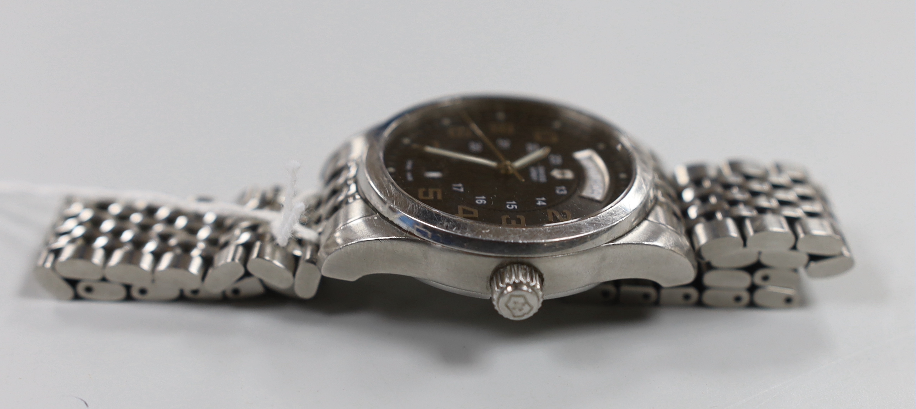 A gentleman's modern stainless steel Swiss Army day/date automatic wrist watch, on a stainless steel bracelet, no box or papers.